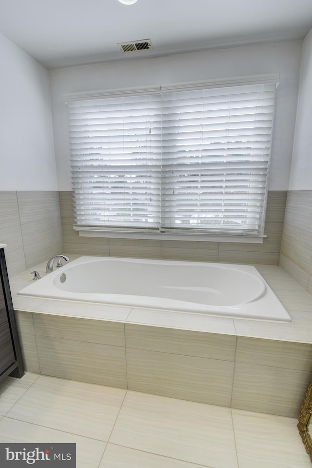 bathroom featuring tiled bath