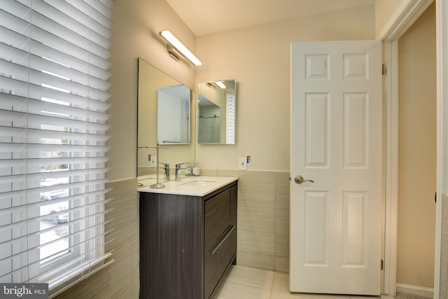 bathroom featuring tile patterned floors, tile walls, and vanity