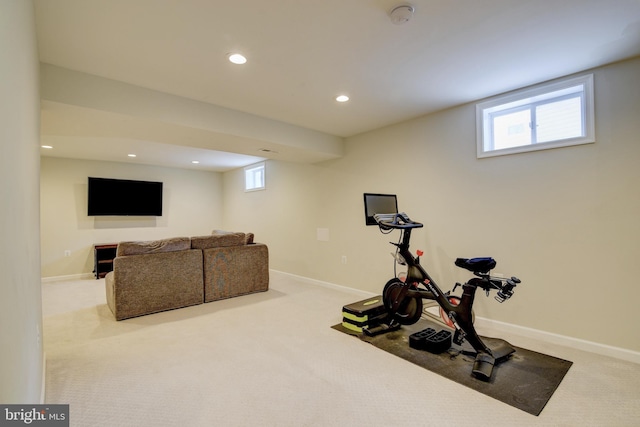 workout area with a healthy amount of sunlight and light colored carpet