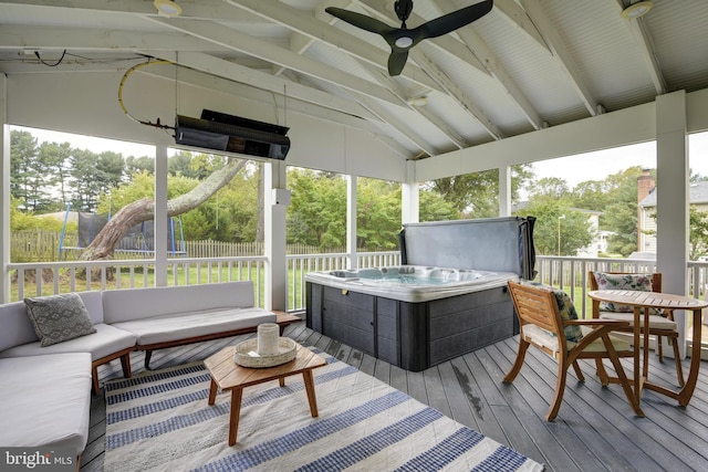 exterior space featuring a hot tub, outdoor lounge area, and ceiling fan