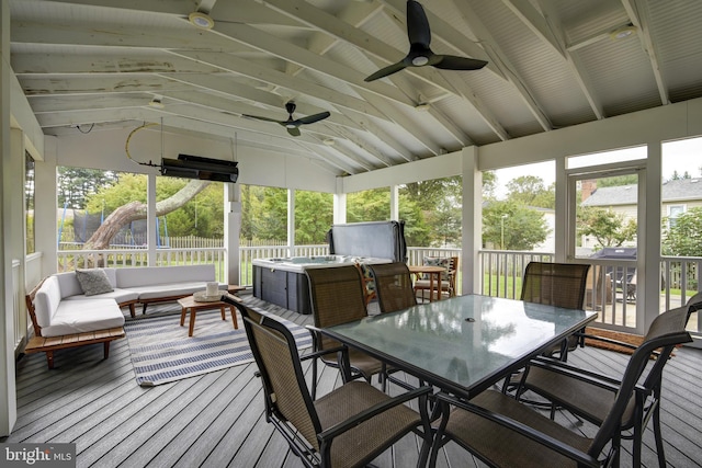 sunroom with vaulted ceiling with beams, plenty of natural light, and ceiling fan