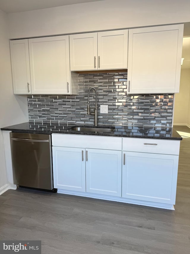 kitchen with dishwasher, sink, hardwood / wood-style floors, and white cabinets