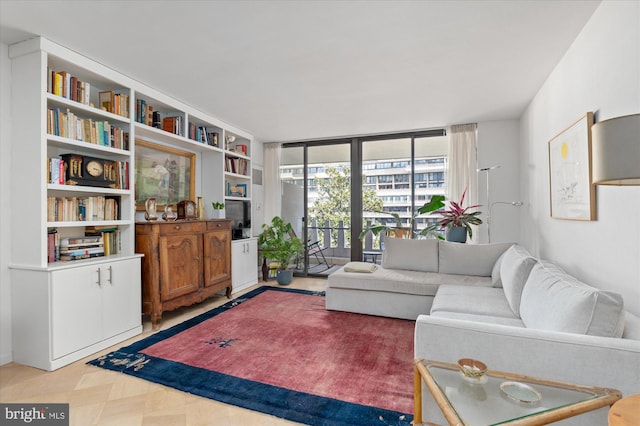 living room featuring built in shelves and a wall of windows