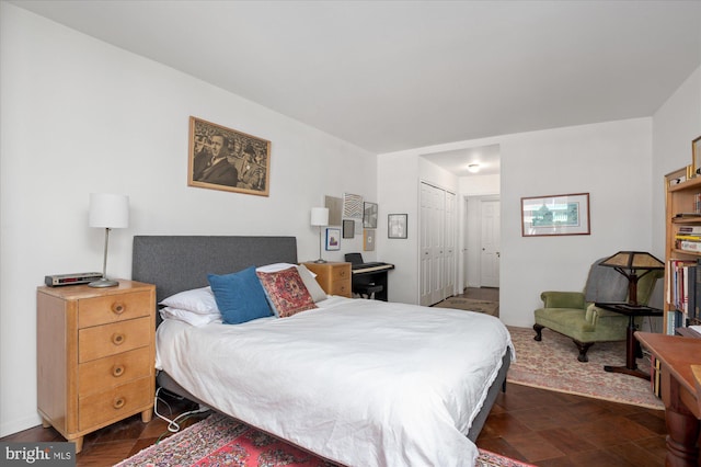 bedroom featuring dark parquet flooring