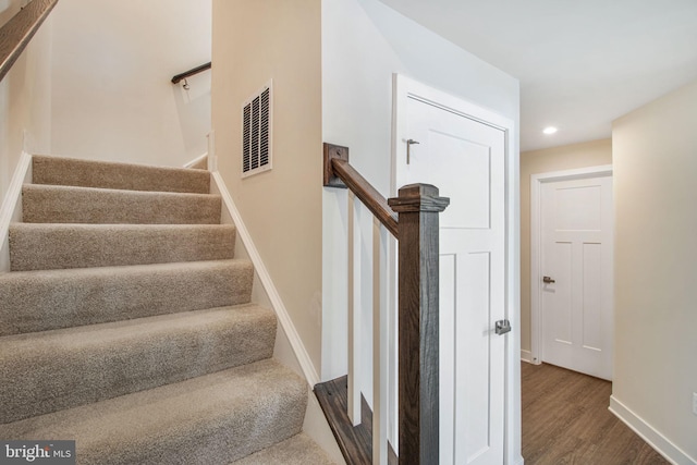 stairs featuring wood-type flooring