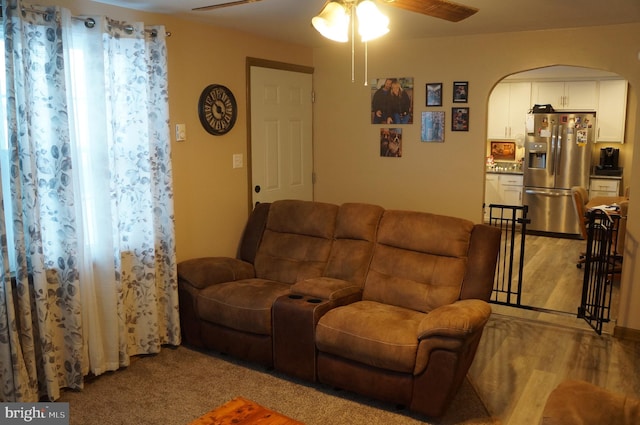 living room with light carpet and ceiling fan