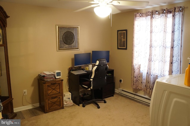 carpeted office featuring a baseboard heating unit, washer / dryer, and ceiling fan