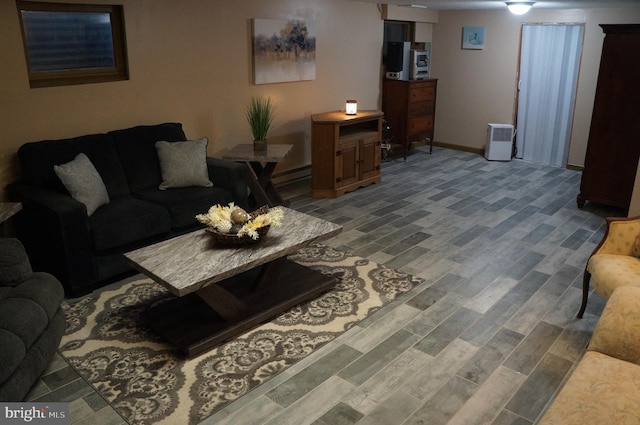 living room featuring baseboard heating and hardwood / wood-style floors