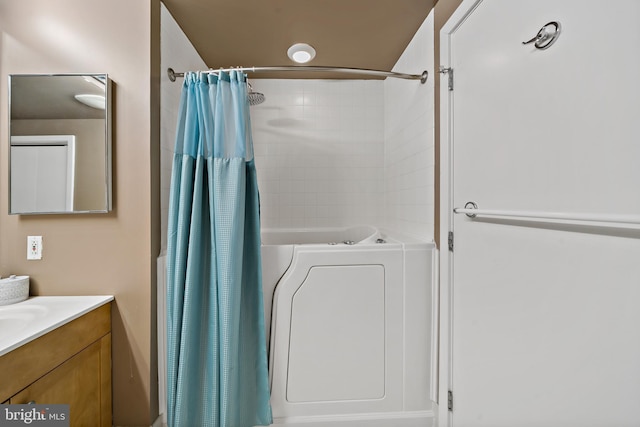 full bath with a shower with curtain, a bathing tub, washer / dryer, and vanity