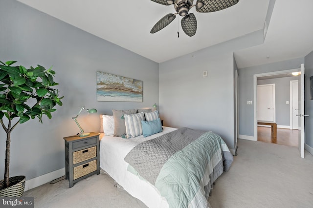 bedroom featuring light carpet, baseboards, and a ceiling fan