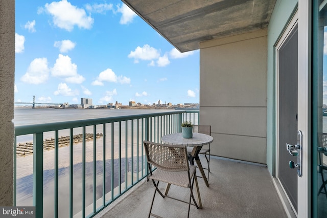 balcony with a view of city and a water view