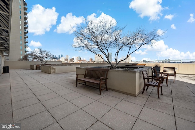 view of patio / terrace featuring a city view