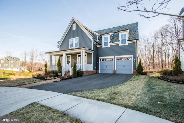 view of front of home with a porch, an attached garage, driveway, and a shingled roof