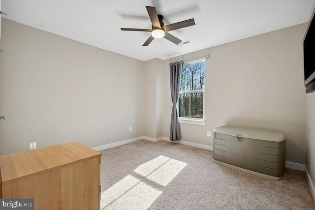 unfurnished bedroom with light carpet, visible vents, a ceiling fan, and baseboards