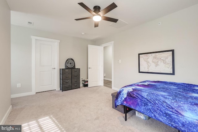 bedroom featuring visible vents, a ceiling fan, baseboards, and carpet floors