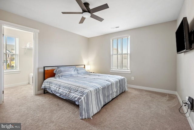 carpeted bedroom featuring visible vents, a ceiling fan, and baseboards