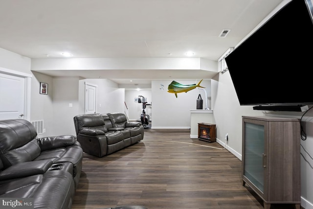living area with recessed lighting, visible vents, baseboards, and dark wood-type flooring