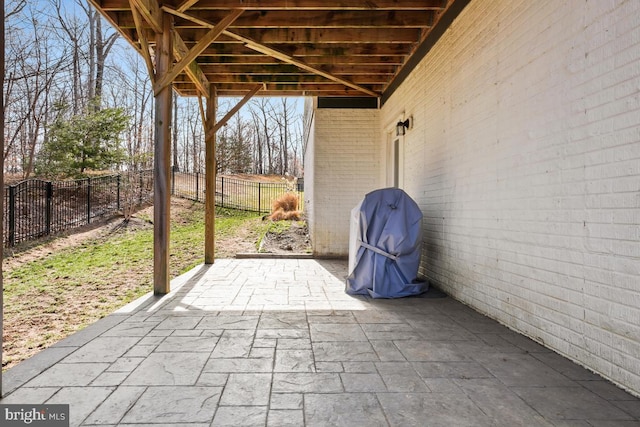 view of patio / terrace with area for grilling and fence