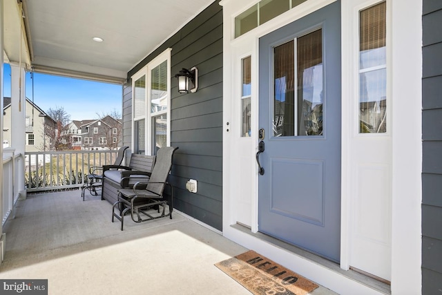 view of exterior entry with covered porch