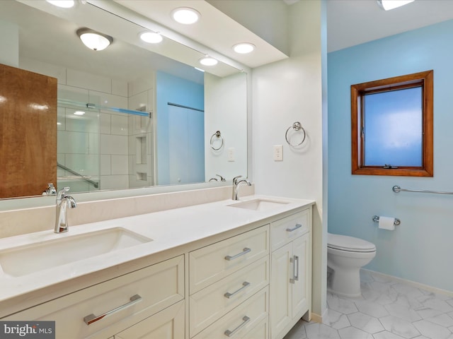 full bathroom with a sink, a shower stall, toilet, and double vanity