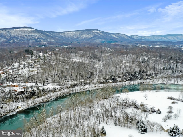 snowy aerial view with a water and mountain view