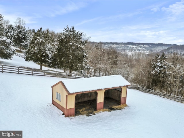 exterior space featuring an outbuilding and fence