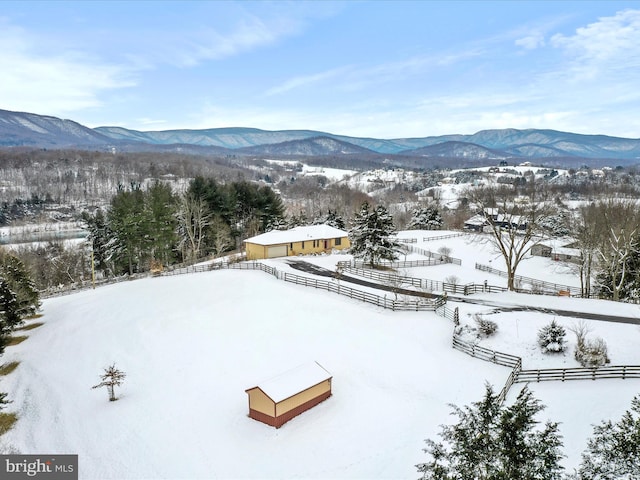 snowy aerial view featuring a mountain view