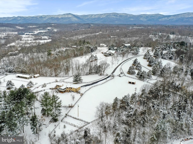 snowy aerial view with a mountain view