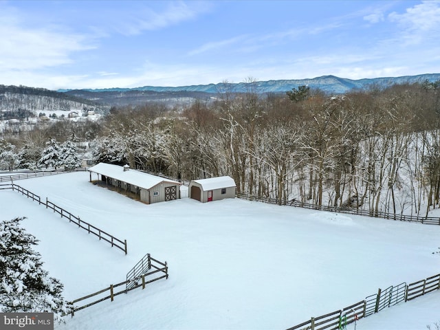 snowy aerial view featuring a mountain view