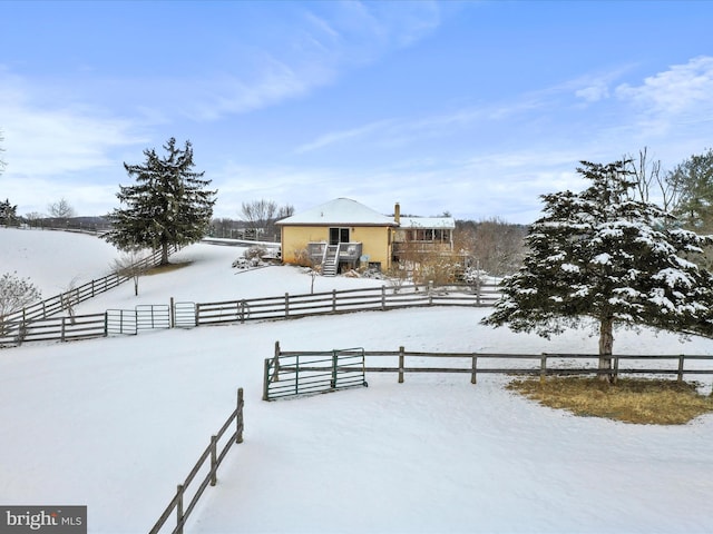 yard covered in snow featuring a fenced front yard