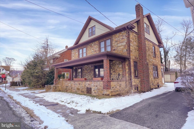 view of snowy exterior with covered porch