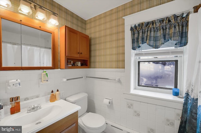 bathroom with vanity, tile walls, and toilet