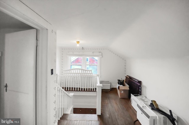 bonus room featuring lofted ceiling and dark hardwood / wood-style flooring