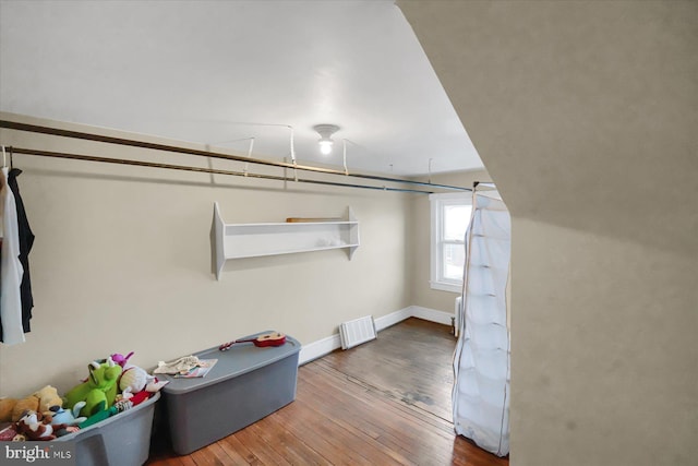 spacious closet with hardwood / wood-style floors