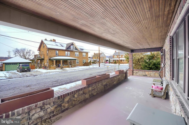 snow covered patio with covered porch