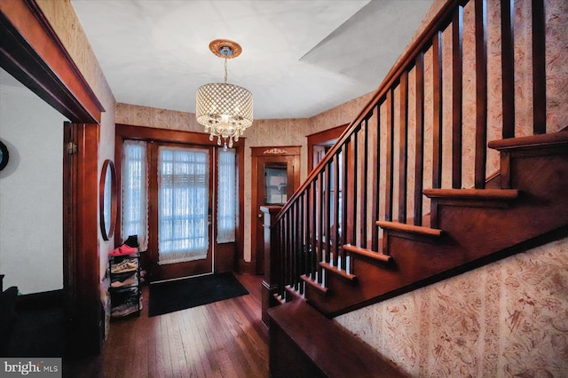 foyer featuring dark hardwood / wood-style flooring and a notable chandelier