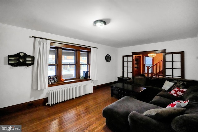 living room featuring dark wood-type flooring and radiator heating unit