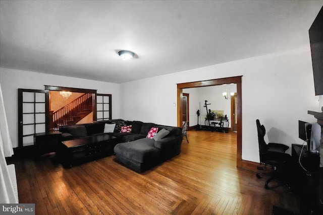 living room with parquet floors and a notable chandelier