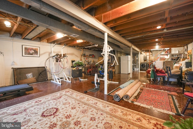 basement with washer / dryer and white refrigerator