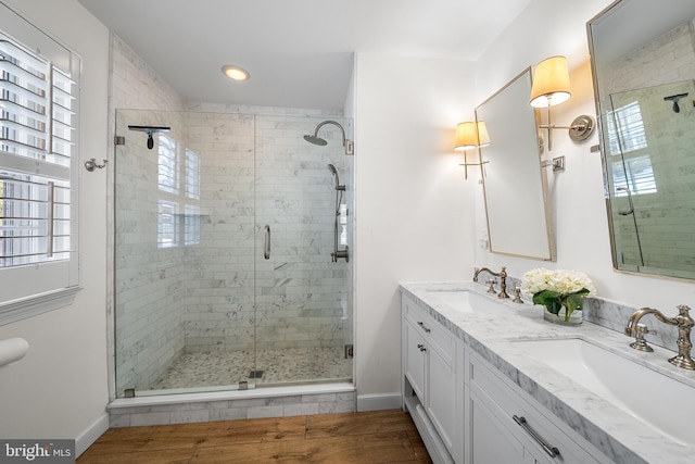 bathroom featuring hardwood / wood-style flooring, vanity, and an enclosed shower