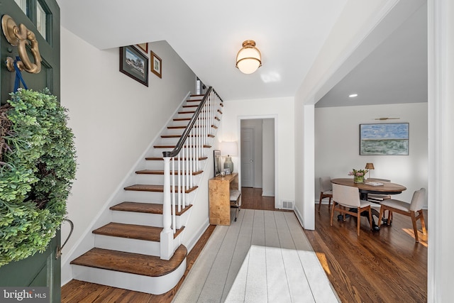 stairway with hardwood / wood-style floors