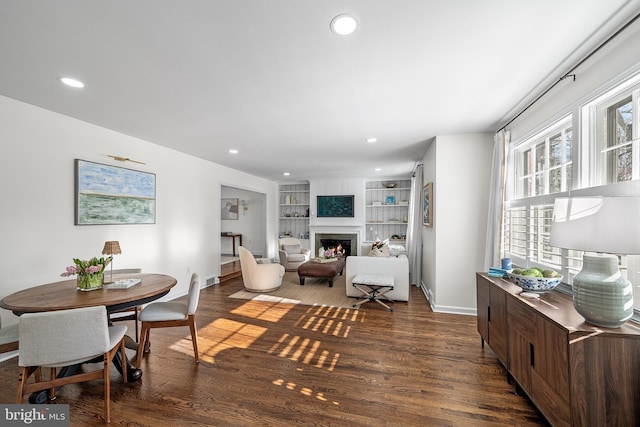 dining space with dark wood-type flooring and built in features