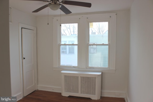 interior space featuring ceiling fan, radiator, and dark hardwood / wood-style flooring