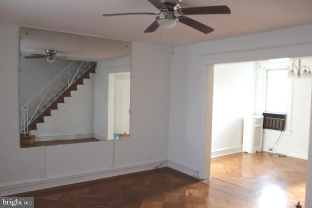 interior space featuring dark parquet flooring and ceiling fan