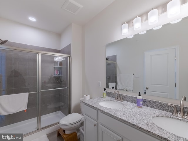 bathroom featuring an enclosed shower, vanity, and toilet