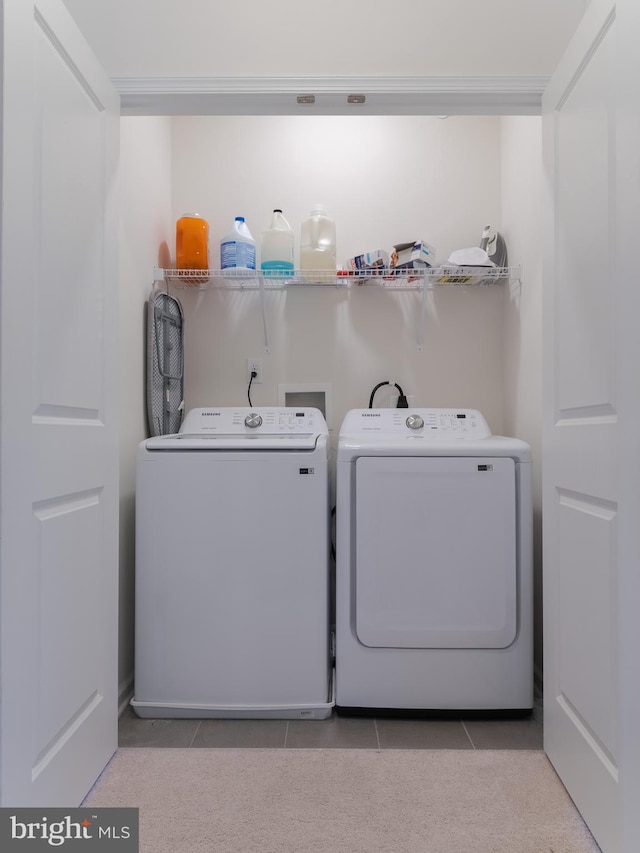 washroom with light tile patterned flooring and washing machine and clothes dryer