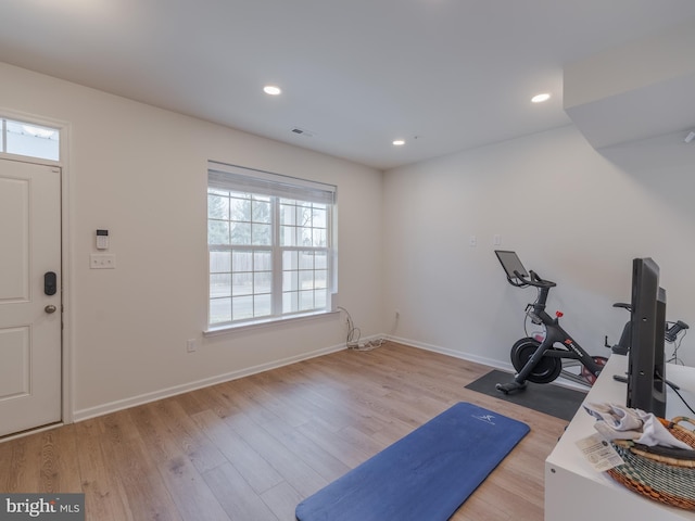 workout room featuring light hardwood / wood-style floors