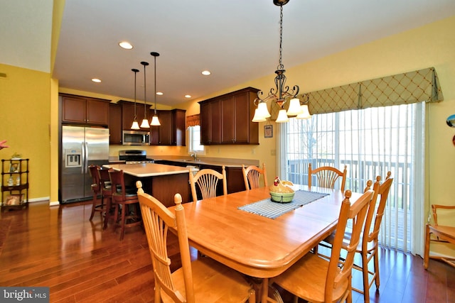 dining space featuring a notable chandelier and dark wood-type flooring