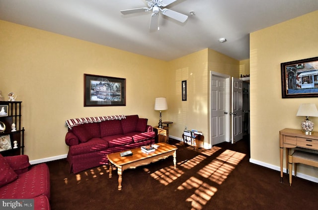 living room with ceiling fan and dark colored carpet