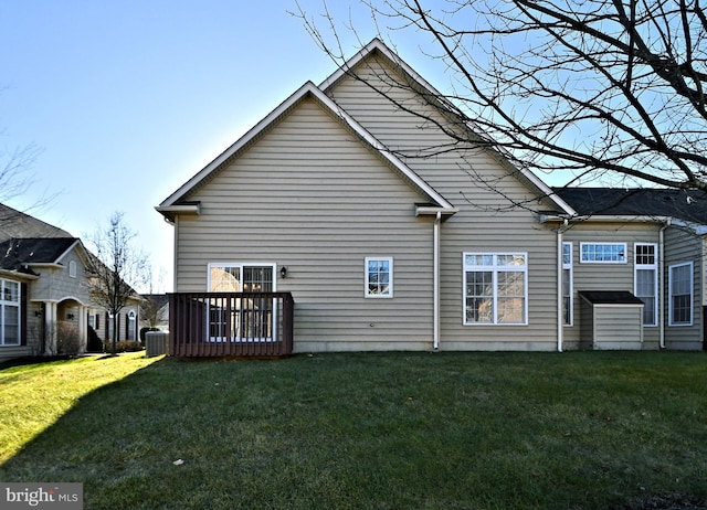 rear view of house featuring a wooden deck, central AC, and a lawn